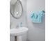 Bathroom features a stylish pedestal sink, a decorative mirror, and a fresh, clean towel, creating a serene ambiance at 2003 Burns View Ln # 2, Lawrenceville, GA 30044