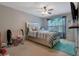Comfortable bedroom with a plush bed, ceiling fan, and ample natural light creating a serene space at 2003 Burns View Ln # 2, Lawrenceville, GA 30044