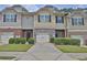 Charming townhome featuring a stone facade, one-car garage, and manicured landscaping at 2003 Burns View Ln # 2, Lawrenceville, GA 30044