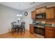 Charming eat-in kitchen features stainless steel appliances, wood cabinets, and a cozy dining area with a chandelier at 2003 Burns View Ln # 2, Lawrenceville, GA 30044