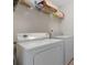 Functional laundry room featuring a modern washer and dryer, with storage shelves, making chores easy at 2003 Burns View Ln # 2, Lawrenceville, GA 30044