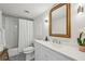 Well-lit bathroom featuring a vanity, gold mirror, and a shower-tub combination at 2870 Pharr Court South Nw # 2404, Atlanta, GA 30305