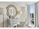 Bedroom featuring a window with city views, a vanity with a decorative mirror, and natural light at 2870 Pharr Court South Nw # 2404, Atlanta, GA 30305