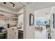 Modern kitchen with stainless steel appliances, open shelving, and a view into the sunlit living room at 2870 Pharr Court South Nw # 2404, Atlanta, GA 30305