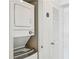 A compact laundry area with stacked washer and dryer, plus a linen closet at 2870 Pharr Court South Nw # 2404, Atlanta, GA 30305