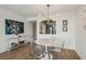Bright living room showcasing the clear table and chairs, hardwood flooring, and stainless steel appliances at 2870 Pharr Court South Nw # 2404, Atlanta, GA 30305