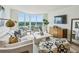 Comfortable living room featuring light neutral finishes and large windows at 2870 Pharr Court South Nw # 2404, Atlanta, GA 30305