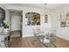 Bright room boasts modern decor, hard floors, an adjacent kitchen, and a clear table with clear chairs at 2870 Pharr Court South Nw # 2404, Atlanta, GA 30305
