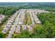 Aerial view of a residential neighborhood featuring manicured lawns, tree-lined streets, and charming homes at 333 Gardens Of Harmony Dr, Canton, GA 30115