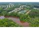 Panoramic aerial view of homes surrounding a lake with community amenities in the distance at 333 Gardens Of Harmony Dr, Canton, GA 30115