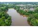 Aerial view of a lake with surrounding trees and homes in a residential neighborhood at 333 Gardens Of Harmony Dr, Canton, GA 30115
