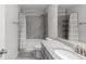 Bathroom featuring a vanity with granite countertop, and a shower-tub with tiled walls at 333 Gardens Of Harmony Dr, Canton, GA 30115