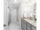 Elegant bathroom with granite countertops, a glass-enclosed shower, and marble floors, creating a spa-like experience at 333 Gardens Of Harmony Dr, Canton, GA 30115