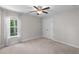 Bright bedroom with a ceiling fan, window with sheer curtains and a closet at 333 Gardens Of Harmony Dr, Canton, GA 30115