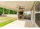Inviting covered patio with a brick fireplace and mounted television, perfect for outdoor entertaining and relaxation at 333 Gardens Of Harmony Dr, Canton, GA 30115