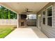 Inviting covered patio with a brick fireplace and mounted television, perfect for outdoor entertaining and relaxation at 333 Gardens Of Harmony Dr, Canton, GA 30115
