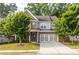 Charming two-story home with a brick and siding facade, well-manicured lawn, and an attached two-car garage at 333 Gardens Of Harmony Dr, Canton, GA 30115
