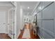 Bright hallway with hardwood floors and decorative wall paneling, leading to other rooms in the house at 333 Gardens Of Harmony Dr, Canton, GA 30115
