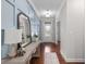Inviting hallway with stylish decor, wood flooring, and custom wall trim detail at 333 Gardens Of Harmony Dr, Canton, GA 30115