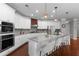 Modern kitchen with granite countertops, stainless steel appliances, and a breakfast bar with pendant lighting at 333 Gardens Of Harmony Dr, Canton, GA 30115