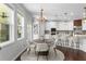 A bright kitchen with a round dining table set in front of large windows for an inviting eating space at 333 Gardens Of Harmony Dr, Canton, GA 30115