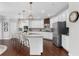 Bright, white kitchen features a large island with seating and modern appliances at 333 Gardens Of Harmony Dr, Canton, GA 30115