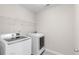 Laundry room featuring a washer, dryer, and wire shelving at 333 Gardens Of Harmony Dr, Canton, GA 30115