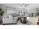 Comfortable living room with large sofa and stylish decor, ceiling fan and bright windows at 333 Gardens Of Harmony Dr, Canton, GA 30115