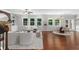 Open-concept living room with hardwood floors, large windows, and a comfortable seating arrangement at 333 Gardens Of Harmony Dr, Canton, GA 30115