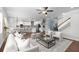 Open-concept living room with modern furniture and hardwood floors adjacent to a stylish kitchen with a large island at 333 Gardens Of Harmony Dr, Canton, GA 30115