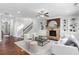 Spacious living room featuring a stone fireplace, custom built-ins, and modern furniture, perfect for entertaining at 333 Gardens Of Harmony Dr, Canton, GA 30115