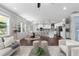 Open-concept living space with hardwood floors, connecting the living room, dining area, and kitchen at 333 Gardens Of Harmony Dr, Canton, GA 30115