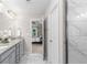 Bathroom featuring double sinks, granite counters, tile floors, and marble-tiled shower at 333 Gardens Of Harmony Dr, Canton, GA 30115