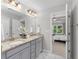 This main bathroom features double sinks, granite countertops, and neutral decor at 333 Gardens Of Harmony Dr, Canton, GA 30115
