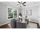Bright office space with a large window, modern desk and plush seating, perfect for working from home at 333 Gardens Of Harmony Dr, Canton, GA 30115