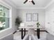 Bright home office with a large window, neutral walls, and a comfortable seating area at 333 Gardens Of Harmony Dr, Canton, GA 30115