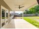 Covered patio featuring a ceiling fan, neutral colors, and views of the spacious backyard, accessible through French doors at 333 Gardens Of Harmony Dr, Canton, GA 30115