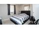Cozy bedroom with a bed, window with gray curtains, and neutral-toned walls at 377 Black Oak Ct, Lawrenceville, GA 30046
