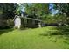 Exterior of a cozy home with a green lawn and mature trees at 377 Black Oak Ct, Lawrenceville, GA 30046
