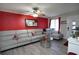 Cozy living room with a comfortable sofa, a glass table, a red accent wall and ample natural light at 377 Black Oak Ct, Lawrenceville, GA 30046