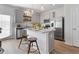 Well-lit kitchen featuring granite countertops, stainless steel appliances, and an island with stylish barstool seating at 109 Meadowview Dr, Temple, GA 30179