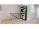 Upstairs hallway with decorative bookcase and carpeted floors at 111 Meadowview Dr, Temple, GA 30179