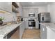 Modern kitchen featuring stainless steel appliances, granite countertops, and ample cabinet space at 111 Meadowview Dr, Temple, GA 30179