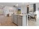 Bright, open-concept kitchen featuring an island, modern light fixtures, and eat-in nook at 111 Meadowview Dr, Temple, GA 30179