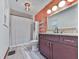 Bathroom featuring a modern vanity, updated fixtures, and wood paneling at 215 Little Brook Ln, Woodstock, GA 30188