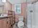 Bathroom with updated vanity, decorative patterned walls and shower with glass door at 215 Little Brook Ln, Woodstock, GA 30188