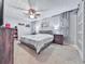 Bedroom features neutral decor, a ceiling fan, and carpeted flooring at 215 Little Brook Ln, Woodstock, GA 30188