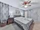 Bedroom boasts neutral decor, a ceiling fan, a comfortable bed, and ample natural light at 215 Little Brook Ln, Woodstock, GA 30188