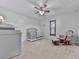 Cozy Bedroom features a gray crib, rocking chair, and neutral decor for a calming environment at 215 Little Brook Ln, Woodstock, GA 30188