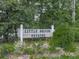 Little Brook Estates community sign surrounded by lush greenery and flowers at 215 Little Brook Ln, Woodstock, GA 30188
